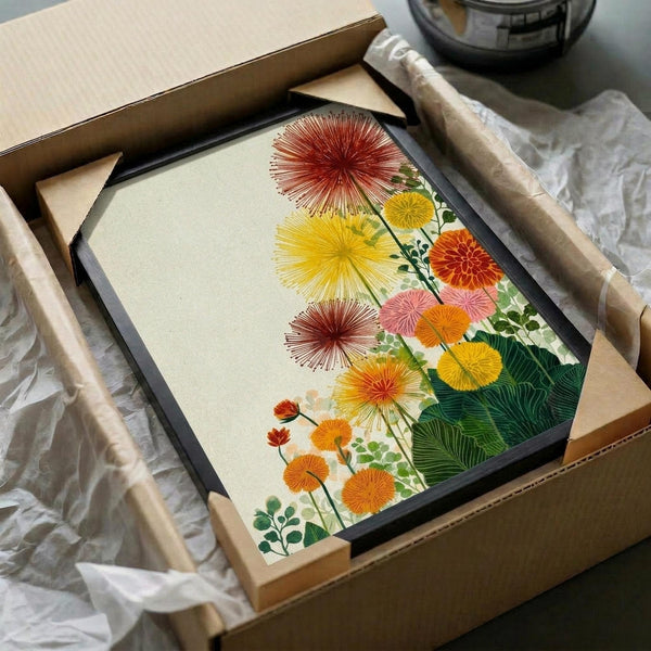 May include: Framed botanical print featuring colorful sunburst-style flowers in red, yellow, orange and pink tones with green foliage, displayed in black frame nestled in cardboard shipping box with protective tissue paper and wooden corner guards