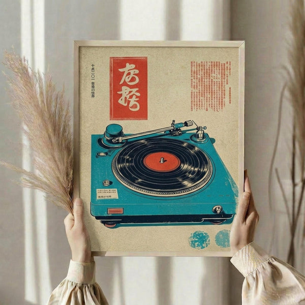 May include: Person holding framed vintage-style poster featuring turquoise record player with red vinyl record, Japanese text in red box, beige textured background, dried wheat stems visible to left, soft natural lighting near window with curtains, cream colored clothing sleeves visible