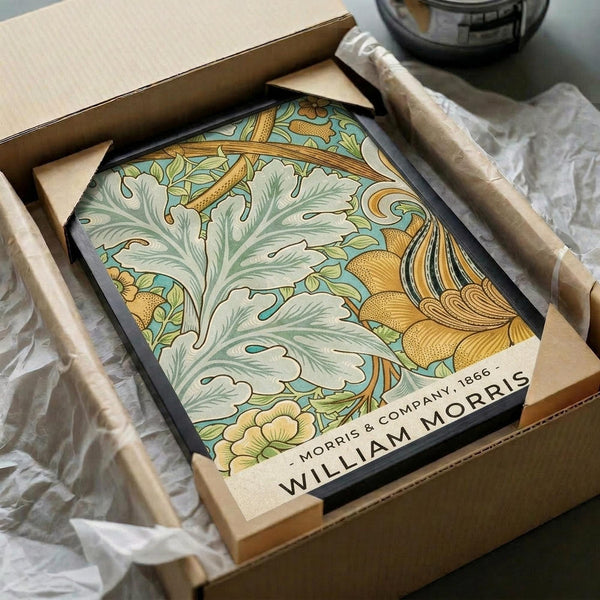 May include: Vintage botanical poster with ornate Art Nouveau floral design featuring flowing acanthus leaves in sage green, golden yellow blooms, and turquoise background, displayed in black frame inside kraft cardboard packaging with protective tissue paper wrapping on neutral surface