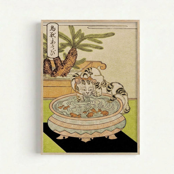 Traditional Japanese woodblock print featuring a striped tabby cat drinking from an ornate ceramic bowl filled with water and goldfish. The cat is positioned on a green tatami mat beside decorative pine cones and evergreen branches. Japanese characters appear in a text box in the upper left corner. The artwork displays classic ukiyo-e style with muted earth tones and delicate line work, presented in a simple wooden frame against a white background.