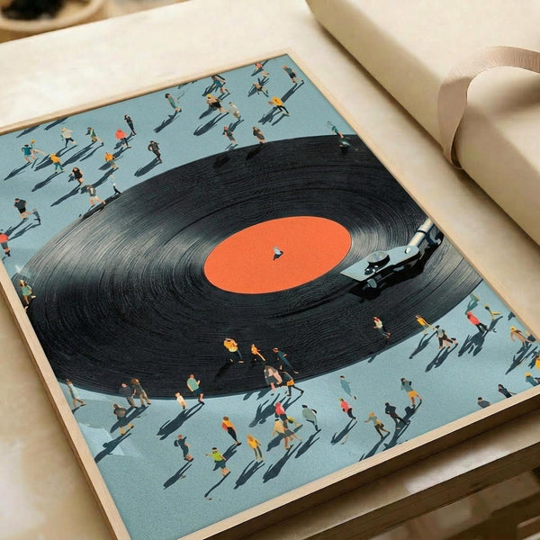 May include: Framed art print showing a large black vinyl record with orange center label and tonearm, surrounded by tiny people figures casting shadows on light blue background, displayed on white bedding next to rolled paper in soft natural lighting