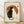 May include: Framed poster print leaning against white wall on light wooden floor. Artwork shows black and white cats in yin-yang pose against orange circle backdrop with Japanese calligraphy characters. Vintage cream-colored paper texture with distressed edges. Natural wood frame in light finish. Soft natural lighting creates subtle shadows on wall.