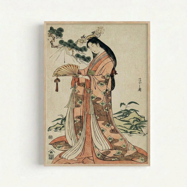 Japanese woodblock print in light wooden frame showing an elegant woman in flowing coral and cream kimono with floral patterns, holding a decorative fan. She has long black hair adorned with ornamental hairpins and stands among stylized pine trees and foliage. The artwork features traditional ukiyo-e style with muted earth tones against a cream background, displaying classic Japanese calligraphy and artist seals in the composition.