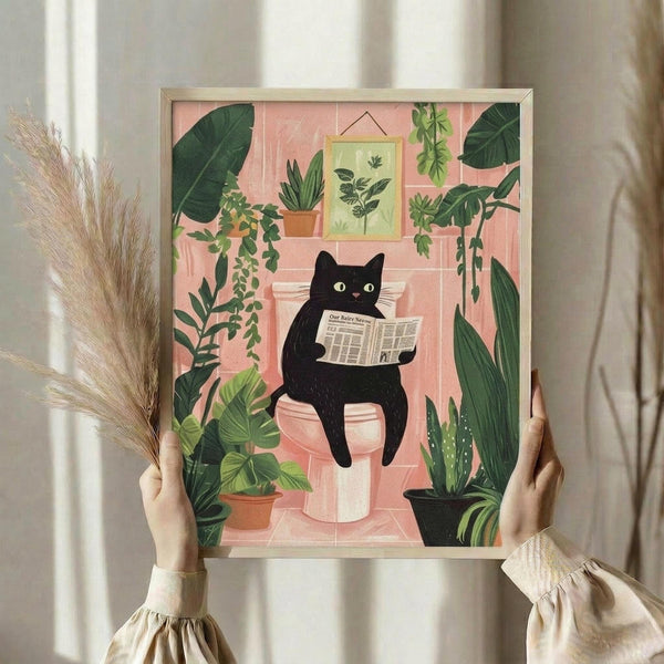 May include: Person holding framed poster featuring black cat reading newspaper while sitting on pink toilet, surrounded by lush green houseplants including trailing vines and potted succulents. Pink bathroom setting with botanical wall art. Golden wheat stems visible beside person wearing cream ruffle-sleeve top.
