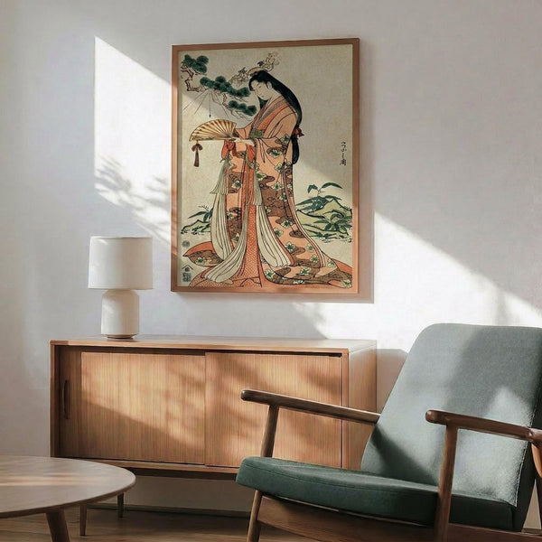May include: Japanese woodblock print artwork showing a woman in elaborate orange and coral kimono holding a decorative fan, displayed in wooden frame above mid-century modern walnut credenza with ceramic table lamp, next to sage green upholstered armchair with wooden arms in sunlit room with white walls