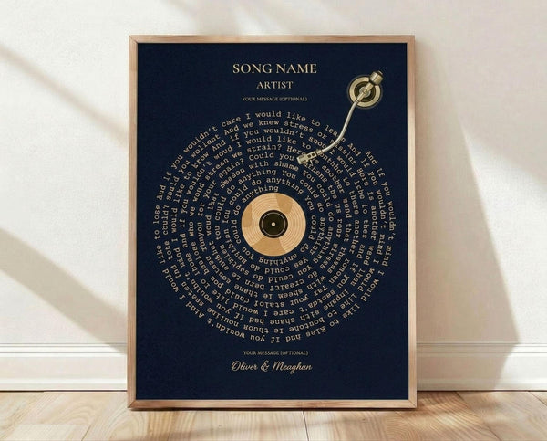 May include: A framed poster with navy blue background featuring song lyrics arranged in a spiral pattern around a golden vinyl record design. The text includes placeholders for song name, artist, and personal message at top, with "Oliver & Meaghan" at bottom. A golden turntable arm extends from upper right. Wood frame sits on light wooden floor against white wall with natural lighting creating soft shadows.