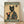 May include: Framed poster print leaning against white wall on light wood floor. Features vintage Japanese woodblock-style artwork of black cat in traditional green kimono with floral pattern, holding red tea cup. Text reads "MORE ESPRESSO" at top and "LESS DEPRESSO" at bottom in cream letters on dark green bands. Japanese characters visible in upper right corner.
