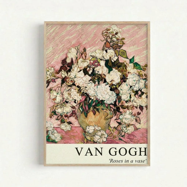 Van Gogh painting reproduction poster showing white roses in a golden vase against a pink diagonal-striped background. The artwork features thick, expressive brushstrokes characteristic of post-impressionist style. White and cream colored roses with green and brown foliage fill an earthenware vase, with scattered rose petals on the pink surface below. The print is displayed in a light wooden frame against a white wall, with "VAN GOGH" and "Roses in a vase" text at the bottom.