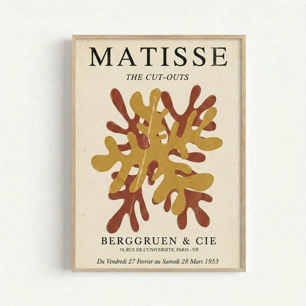 Framed vintage exhibition poster featuring Henri Matisse's abstract cut-out artwork in mustard yellow and rust red coral-like shapes on cream background. Black text reads "MATISSE THE CUT-OUTS" at top, "BERGGRUEN & CIE" gallery information below the artwork, with exhibition dates in French from 1953. Light wood frame against white wall background.
