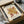 May include: Framed vintage-style art print featuring Matisse's abstract tree design in warm golden yellow and reddish-brown colors on cream background, displayed in black frame inside brown cardboard shipping box with white tissue paper packaging on light surface