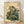 May include: Framed poster print leaning against white wall on light wood floor. Artwork shows anthropomorphic frog in traditional Japanese style wearing ornate teal and gold patterned kimono, smoking long pipe with wisps of smoke curling upward. Frog sits among green foliage with Japanese characters in upper right corner. Aged cream background gives vintage woodblock print appearance. Natural wood frame surrounds the piece.