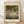 May include: Framed art print of Claude Monet's impressionist garden painting featuring vibrant purple and pink flowers in foreground with lush green trees overhead. Light wooden frame on cream matting displays the colorful Giverny garden scene with soft, painterly brushstrokes typical of Monet's style. Print sits on light wooden floor against white textured wall with natural lighting creating gentle shadows.