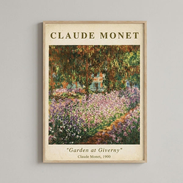 May include: Framed poster print of Claude Monet's impressionist garden painting featuring vibrant purple and pink flowers in foreground with lush green foliage and trees creating a canopy overhead. The artwork shows Monet's signature loose brushwork and bright color palette. Natural wood frame with cream matting displays the print on a light gray wall.
