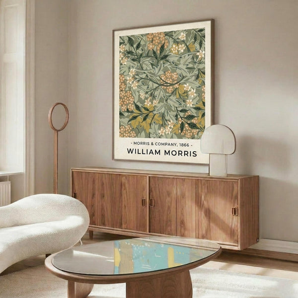 May include: Framed botanical print with green foliage and orange berry pattern mounted above mid-century walnut credenza. Modern white curved chair and oval glass coffee table with colorful abstract art visible through transparent surface. Minimalist room setting with beige walls and natural lighting.