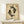 May include: Framed poster with two black koi fish in yin-yang formation on aged beige background with red and black Asian characters and "LOSE YOUR MIND FIND YOUR SOUL" text, displayed on light wood surface next to small white wrapped gift with green sprig accent against cream wall