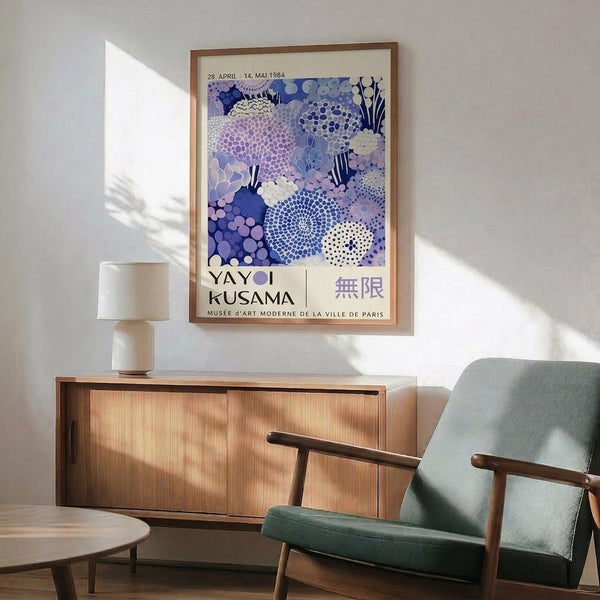 a poster of Yayoi Kusama's "Musee de la Ville de Paris" exhibition, hanging on a wall in a living room setting.