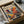 a framed artwork with a vibrant, abstract design inside a cardboard box.