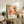 a framed poster of a colorful abstract artwork, placed on a wooden cabinet or shelf in a living room setting.