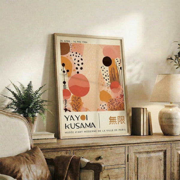 a framed poster of a colorful abstract artwork, placed on a wooden cabinet or shelf in a living room setting.