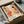 a framed poster or artwork with a colorful abstract design, placed in a cardboard box.