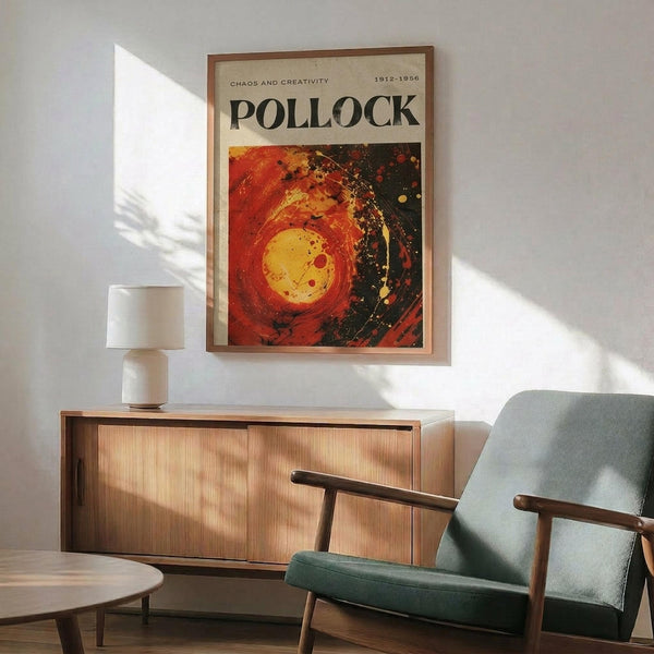 a poster of Pollock's artwork hanging on a wall, with a wooden cabinet below it and a green armchair in the foreground.