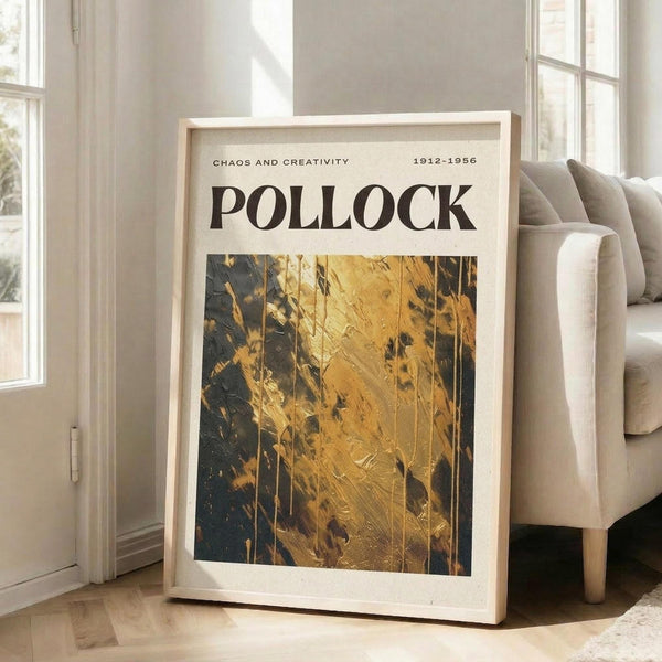 a framed poster with the title "Chaos and Creativity" and the artist's name "Pollock" displayed prominently. The poster is placed on a wooden floor in front of a white couch, creating a cozy and artistic atmosphere.