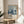 A framed poster of a floral design hangs on a wall, with the text "YAYOI KUSAMA" and "MUSEUM DE LA VILLE DE PARIS" below it.