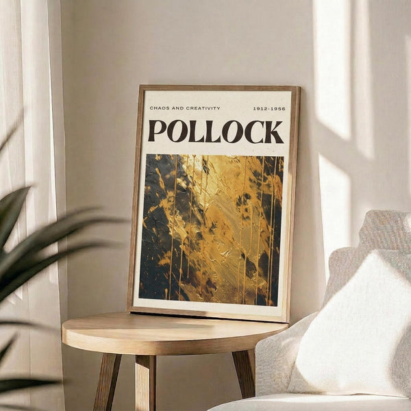 a framed poster of Pollock's painting titled "Chaos and creativity" displayed on a wooden table in a room with a white chair and a plant in the background.