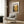 a modern living room with a white armchair, a floor lamp, and a framed poster on the wall.