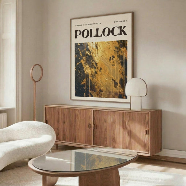 a modern living room with a large wooden cabinet, a white sofa, and a glass coffee table. A framed poster with a gold and black abstract design is hanging on the wall above the cabinet.
