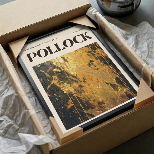 a framed print titled "Pollock" displayed in a cardboard box, with a crumpled white paper surface underneath.