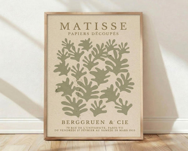The image is a framed poster featuring a repeating pattern of green leaf-like shapes, with text providing information about the artwork.