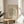 a framed poster of the famous painting "Matsisse" by the artist Henri Matisse, displayed on a wooden table in a room with a white chair and a plant in the background.