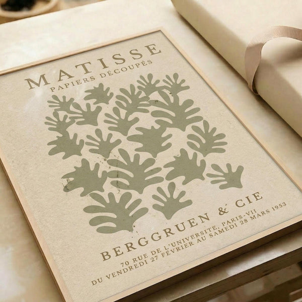 The image is a framed poster featuring a design of green leaf-like shapes arranged in a grid-like pattern.