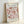 The image is a framed poster featuring a floral design with pink and brown flowers. The poster is titled "MATISSE Papiers Decoupes" and includes the text "BERGGRUEN & CIE" and "70 RUE DE L'UNIVERSITE, PARIS, VI" along with the date "28 MARS 1958".