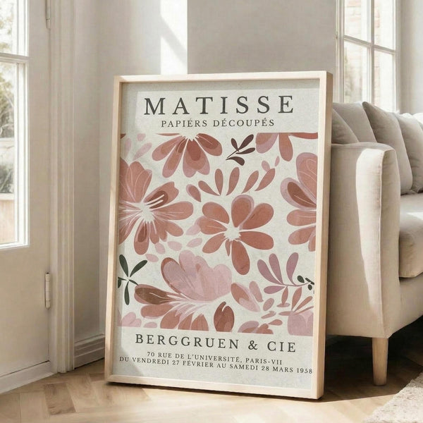 A framed poster of the M.C. Escher's "Paper Flower" artwork, featuring a floral pattern in shades of pink and red.