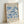 The image is a framed poster featuring a blue floral pattern with the text "MATISSE Papiers Decoupes" and "BERGGRUEN & CIE" printed on it.
