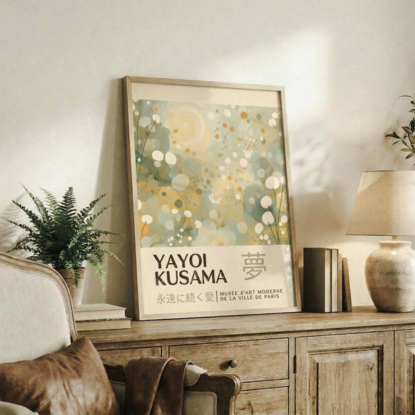 a framed poster of Yayoi Kusama's work displayed on a wooden cabinet in a living room setting.