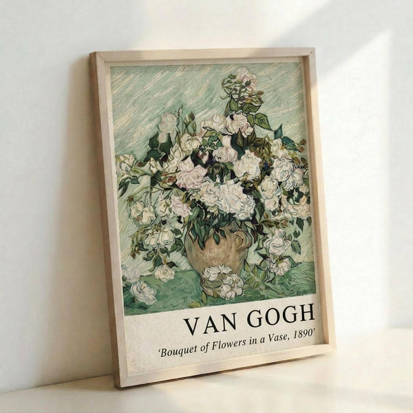 May include: Framed poster print of Van Gogh's floral painting featuring white roses and flowers in a ceramic vase against a green textured background. The artwork shows thick brushstrokes and vibrant colors typical of Van Gogh's style. The print has "VAN GOGH" and "Bouquet of Flowers in a Vase, 1890" text at the bottom in a light wooden frame, leaning against a white wall.