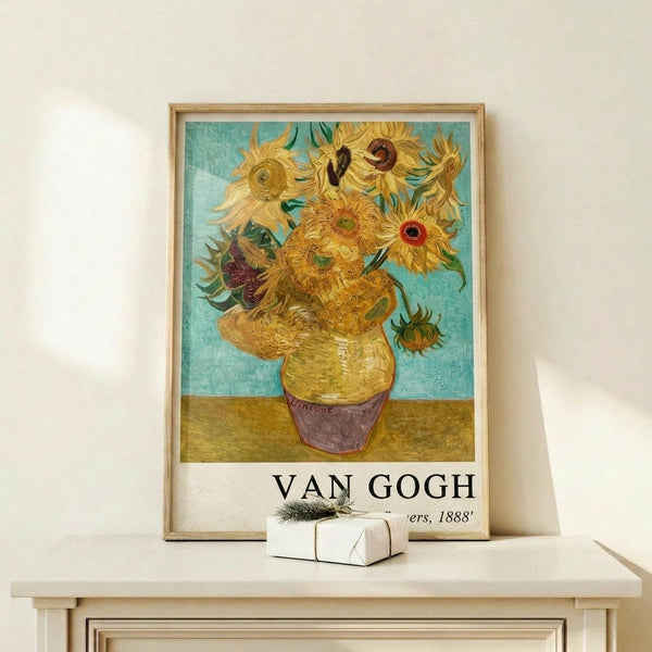 May include: Van Gogh's famous sunflowers painting reproduction in thin wooden frame, displayed on light wood shelf against white wall. Vibrant yellow sunflowers in ceramic vase against turquoise background, with "VAN GOGH" and "1888" text below artwork. Small white wrapped gift box with green sprig sits on shelf next to frame.