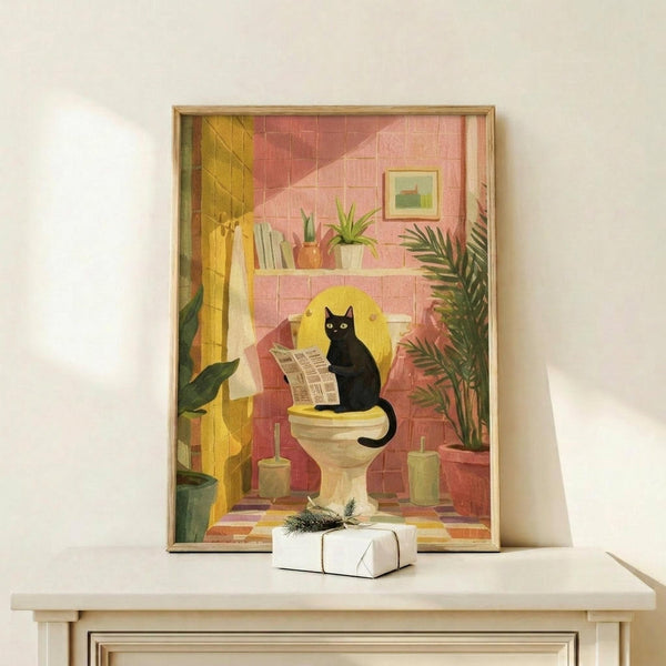 May include: Framed illustration showing a black cat sitting on a toilet reading a newspaper in a colorful bathroom with pink and coral tiled walls, yellow shower curtain, green plants on floating shelf, palm frond, toilet brush, and small framed artwork. Artwork displayed on light wooden shelf with white wrapped gift beside frame.