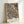 May include: Framed botanical art print leaning against white wall, featuring intricate dark navy background with ornate floral pattern in cream, coral, and rust tones. The design shows detailed flowers, leaves, and vines in Victorian decorative style. Text "WILLIAM MORRIS" appears at bottom in black letters. Natural wood frame with light finish.