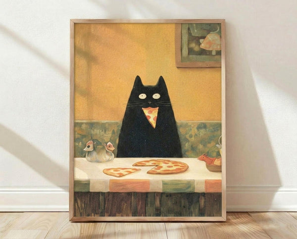 May include: Framed poster print leaning against white wall on wooden floor. Artwork shows black cat with wide white eyes sitting at checkered tablecloth table with pizza slices. Warm yellow-orange wall background with small framed artwork visible. Cat appears to be eating pizza with whimsical, folk art illustration style. Light wooden frame surrounds the print.