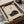 May include: Vintage-style linocut print of a sleeping black cat on cream paper, displayed in a simple black frame inside a cardboard box with tissue paper. Traditional Japanese characters appear above the curled cat silhouette. Wooden printmaking tools lie alongside the framed artwork, suggesting handcrafted block printing technique.