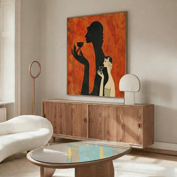 May include: Orange and black Art Deco style poster showing silhouette of woman holding wine glass with smaller blonde woman figure below, displayed above wood credenza in modern living room with white curved chair, oval glass coffee table, and white table lamp
