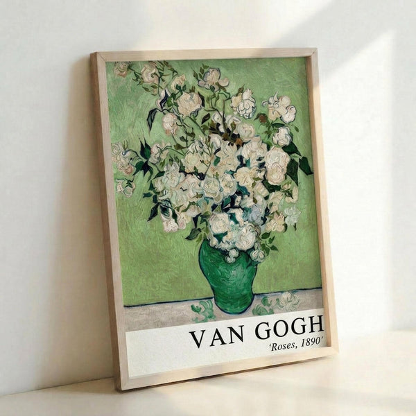 May include: Framed art print of Van Gogh's white roses in green vase against pale green background, displayed in light wood frame leaning against white wall. Post-impressionist painting reproduction features thick brushstrokes and vibrant colors. Print shows museum-style formatting with artist name and date at bottom.