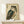 May include: Framed vintage Japanese woodblock print of an owl with detailed feathers in teal, brown, and cream tones, displayed on a light wood shelf against white wall. Japanese characters visible on aged beige background. Small white wrapped package sits beside the wooden frame.