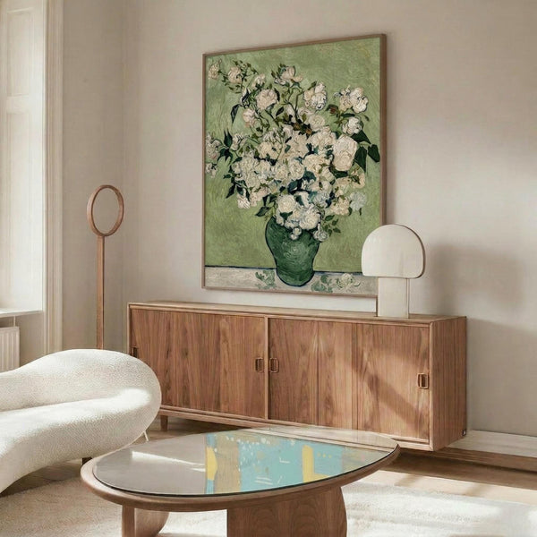 May include: Van Gogh floral painting reproduction featuring white roses in green vase against soft green background, displayed above mid-century modern walnut credenza in minimalist living room with cream chair, oval glass coffee table, and brass floor lamp on light wooden floors.