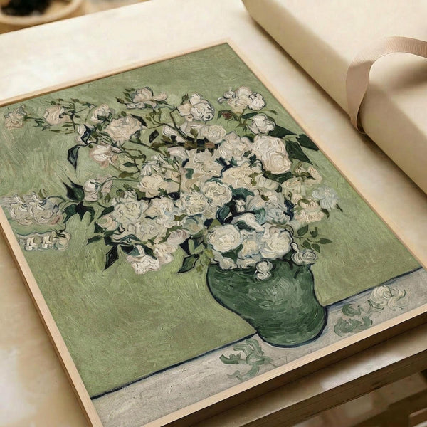 May include: Van Gogh's Roses painting print displayed in white matting with cream ribbon beside it. The artwork shows white roses in a green vase against a sage green background, painted in Van Gogh's characteristic thick brushstroke style. The print appears mounted in professional matting on a light wooden surface.