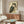 May include: Japanese woodblock print style owl artwork with orange eyes and detailed brown and teal feathers, displayed in thin frame above wooden sideboard in modern living room. White curved chair and glass-top coffee table visible. Vintage Asian calligraphy text on cream background poster.